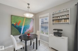 Recessed ceiling light fixture with a glass bowl shade, a white window frame, and a wall-mounted shelving unit - 