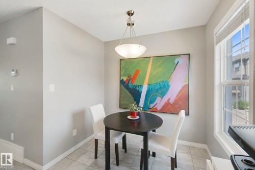 Tile flooring, overhead pendant lighting, light gray wall paint, and white trim - #58 4029 Orchards Dr Sw, Edmonton, AB 