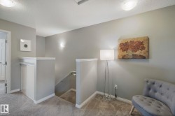 Neutral gray wall color, white trim, recessed ceiling lighting, wall sconce lighting, carpeted flooring - 