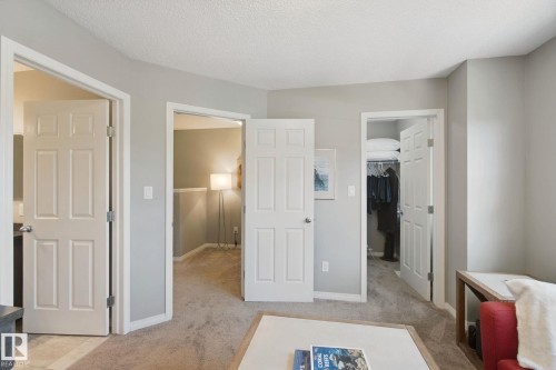 Neutral wall paint, carpet flooring, multiple panel doors, and recessed lighting - #58 4029 Orchards Dr Sw, Edmonton, AB 