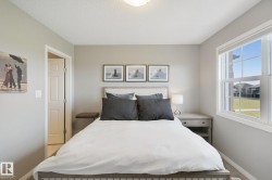 Neutral wall paint with carpet flooring, a single window with white trim, a flush mount ceiling light fixture, and a paneled interior door - 