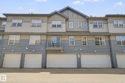 Multi-level exterior with mixed siding, multiple garages, and a private balcony - 