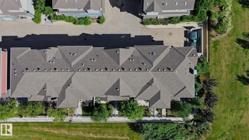 Townhome property featuring a shingle roof and multiple skylights - #58 4029 Orchards Dr Sw, Edmonton, AB 