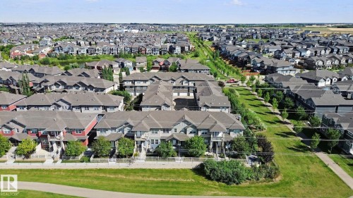 Expansive residential community featuring multiple housing styles, green spaces, and paved pathways - #58 4029 Orchards Dr Sw, Edmonton, AB 