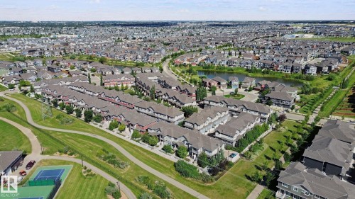 Expansive residential development with a network of pathways, green spaces, and a tennis court - #58 4029 Orchards Dr Sw, Edmonton, AB 