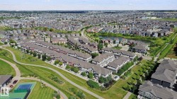 Expansive residential development with a network of pathways, green spaces, and a tennis court - 