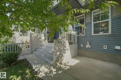 Exterior featuring horizontal siding, white-framed windows, concrete steps, and a concrete patio - 