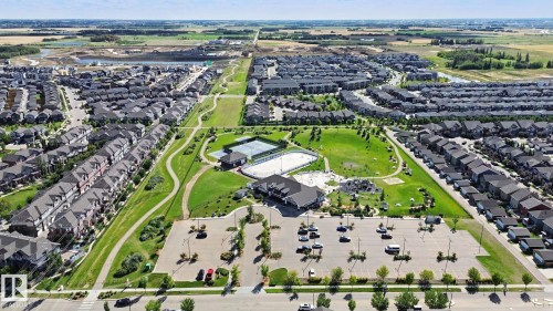 Green spaces with walking paths, tennis courts, and a community building - #58 4029 Orchards Dr Sw, Edmonton, AB 