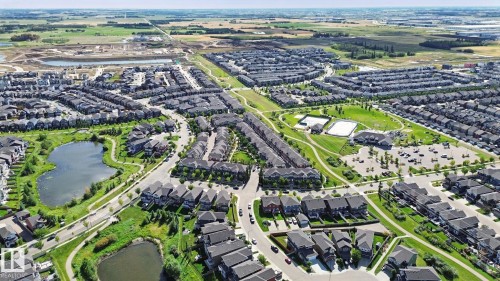Expansive residential community featuring multiple ponds, green spaces, walking paths, and recreational courts - #58 4029 Orchards Dr Sw, Edmonton, AB 
