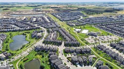 Expansive residential community featuring multiple ponds, green spaces, walking paths, and recreational courts - 