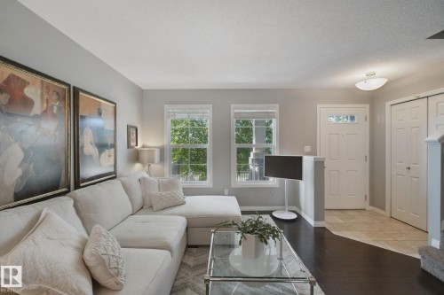 Hardwood-style flooring, white trim, and light gray wall finishes - #58 4029 Orchards Dr Sw, Edmonton, AB 