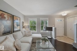 Hardwood-style flooring, white trim, and light gray wall finishes - 