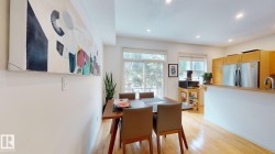 Hardwood flooring, recessed lighting, and a kitchen featuring stainless steel appliances and wood cabinetry - 