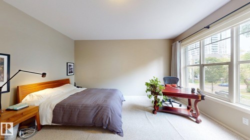 Carpeted room with neutral wall tones and large picture windows - 9846 112 Street Nw, Edmonton, AB 