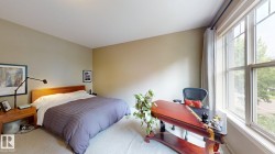 Carpet flooring, neutral wall paint, and a large multi-pane window with drapery rod - 