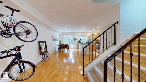Recessed lighting illuminates wood-finish flooring throughout the main level - 9846 112 Street Nw, Edmonton, AB 