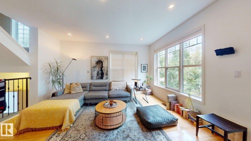Hardwood flooring, recessed lighting, and large windows with white trim - 9846 112 Street Nw, Edmonton, AB 