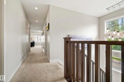Upper-level hallway featuring recessed lighting and neutral carpeting - 