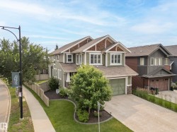 Contemporary two-story residence with a multi-gabled roofline and stone accents - 