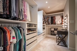 Custom closet system featuring extensive shelving and hanging storage - 