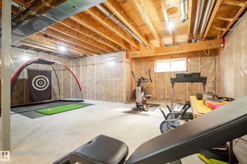 Unfinished basement space featuring exposed joists, ductwork, and a concrete floor - 5966 Edmonds Crescent Nw, Edmonton, AB - Indoor Photo Showing Basement