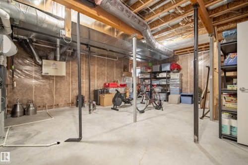 Unfinished basement featuring exposed wood joists, ductwork, and insulation-lined walls - 5966 Edmonds Crescent Nw, Edmonton, AB - Indoor Photo Showing Basement