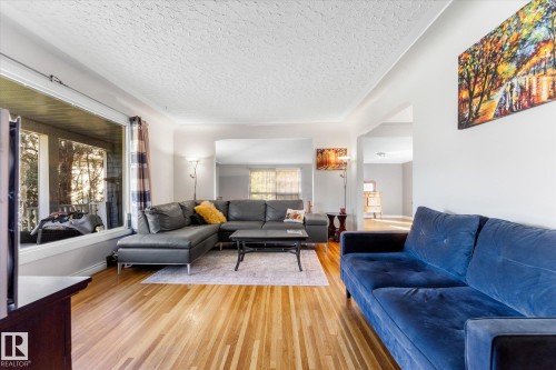 Light wood-finish flooring, white walls, and a textured ceiling - 6054 107A Street Nw, Edmonton, AB 