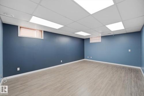 Recessed lighting, drop ceiling, wood-finish flooring, two windows, and blue painted walls - 13304 63 Street Nw, Edmonton, AB 