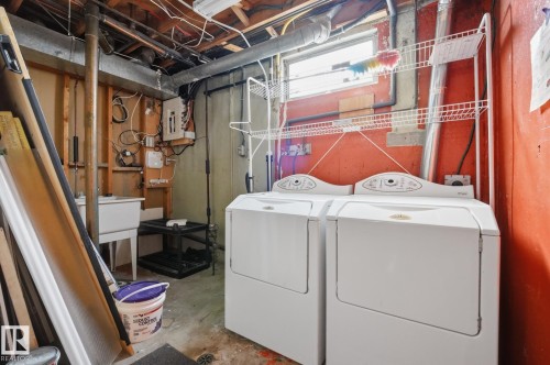 Laundry area featuring a utility sink, a window, and exposed overhead joists - 13304 63 Street Nw, Edmonton, AB 