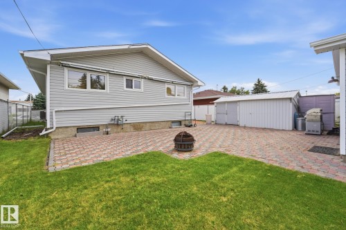 Expansive backyard featuring a paver patio and a separate storage structure - 13304 63 Street Nw, Edmonton, AB 