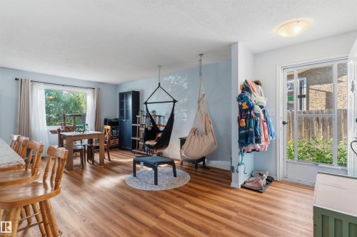 Wood-finish flooring throughout the open concept space - 17005 95 Street Nw, Edmonton, AB 
