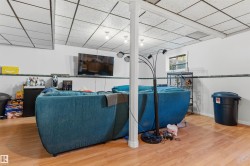 Wood-finish flooring with white walls and a drop ceiling - 