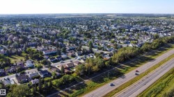 Aerial perspective of a residential neighborhood with a multi-lane roadway - 