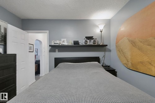 Wall-mounted shelving, arched doorway, and textured ceiling - 12035 83 Street Nw, Edmonton, AB 