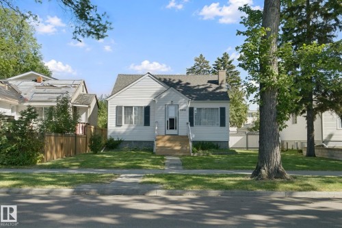 White siding exterior with a grey shingle roof - 12035 83 Street Nw, Edmonton, AB 