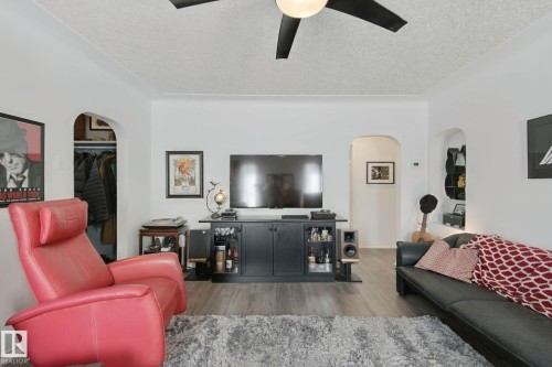 Recessed archways, wood-finish flooring, and a ceiling fan with integrated lighting - 12035 83 Street Nw, Edmonton, AB 