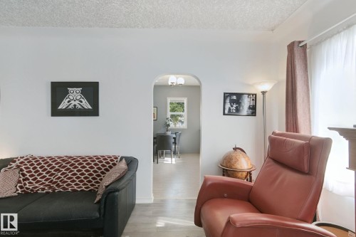 Archway opening to an additional room, white walls, and light-colored flooring - 12035 83 Street Nw, Edmonton, AB 