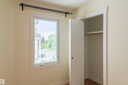 Window with black curtain rods, white trim, and a side-hinged latch - 