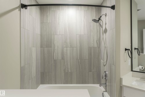 Bathtub and shower combination featuring large format tile surround - 5010 147 Street Nw, Edmonton, AB 