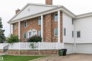 Brick and siding exterior with a prominent portico featuring four columns - 5010 147 Street Nw, Edmonton, AB 
