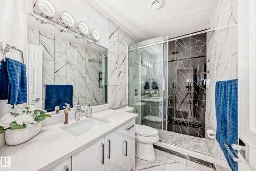 Integrated vanity with a single basin, polished chrome faucet, and under-cabinet storage - 4608 43 Avenue Nw, Edmonton, AB 