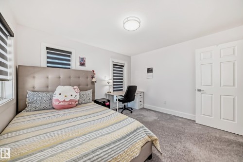 Recessed ceiling light fixture, white paneled door, three windows with horizontal blinds, and grey carpeting - 4608 43 Avenue Nw, Edmonton, AB 