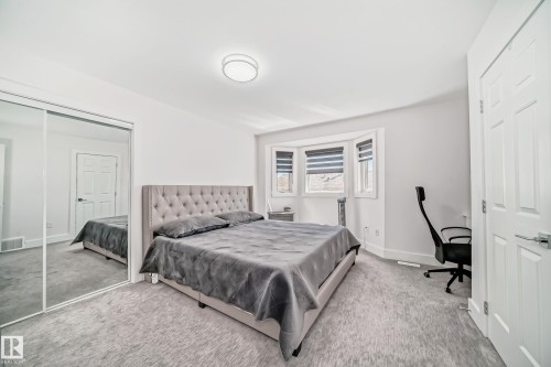 Recessed lighting, bay windows with blinds, mirrored closet doors, and light gray wall paint - 4608 43 Avenue Nw, Edmonton, AB 