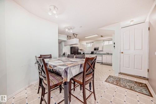Kitchen with white cabinetry, a built-in microwave, and a double-basin sink - 4608 43 Avenue Nw, Edmonton, AB 
