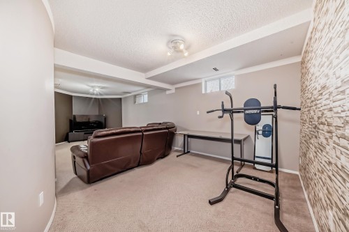 Recessed lighting, textured accent wall, light-colored carpeting, window, and track lighting - 4608 43 Avenue Nw, Edmonton, AB 