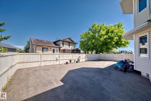 Paved outdoor space with a full-height perimeter fence - 4608 43 Avenue Nw, Edmonton, AB 
