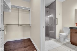 Walk-in closet featuring wood-finish flooring and integrated shelving - 