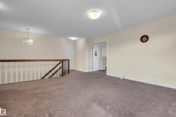 Upper level landing featuring neutral carpeting, light cream wall paint, and a white ceiling - 