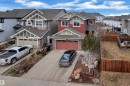 Modern multi-story residence featuring red siding and stone accents - 3071 Carpenter Landing Sw, Edmonton, AB 