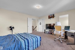 Carpeted room featuring light-colored walls and a semi-flush mount ceiling light - 